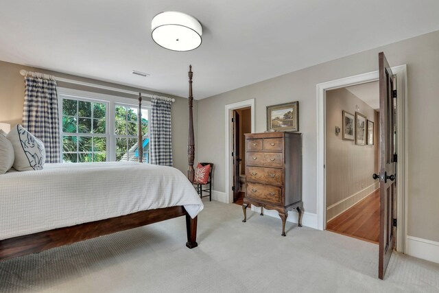 bedroom featuring wood-type flooring, connected bathroom, crown molding, and ceiling fan