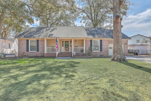 ranch-style house featuring a porch, brick siding, and a front lawn