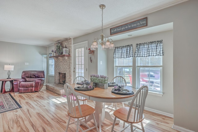 dining area featuring a wealth of natural light, a fireplace, and wood finished floors