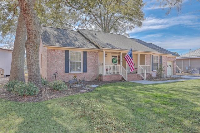 ranch-style home with brick siding, roof with shingles, covered porch, a garage, and a front lawn