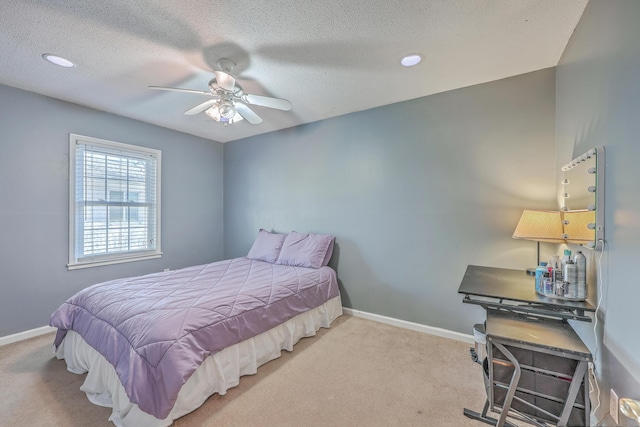 bedroom with carpet, a textured ceiling, and baseboards