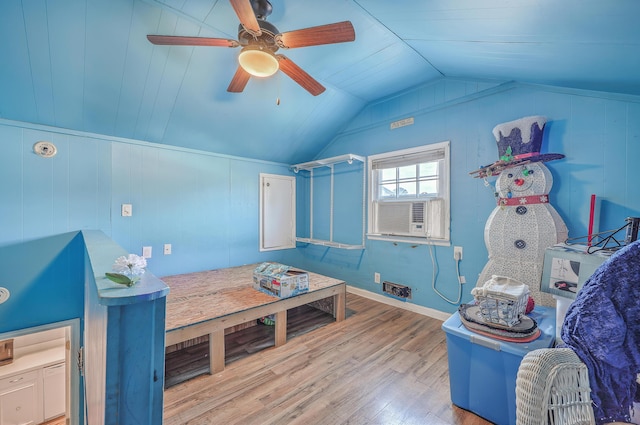 bedroom with ceiling fan, cooling unit, vaulted ceiling, and wood finished floors