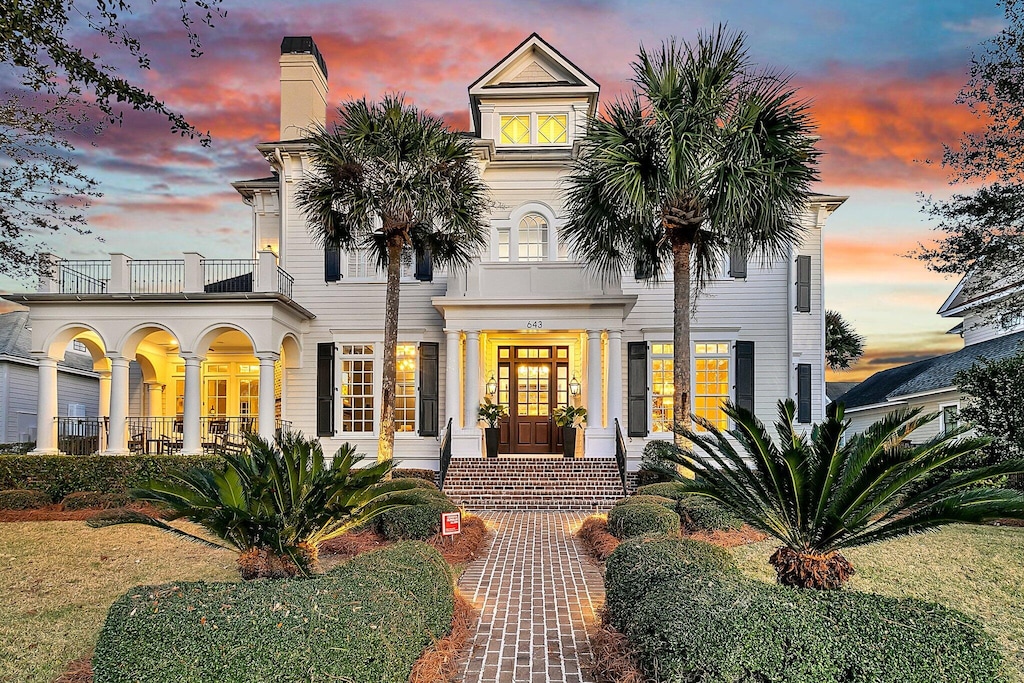 view of front of house featuring french doors and a balcony