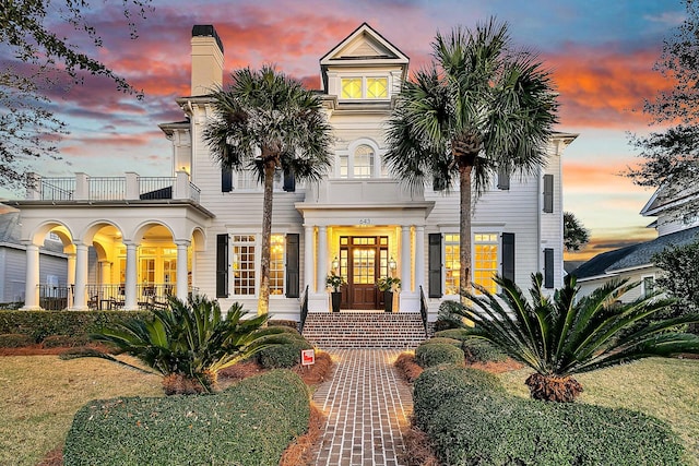 view of front of house featuring french doors and a balcony