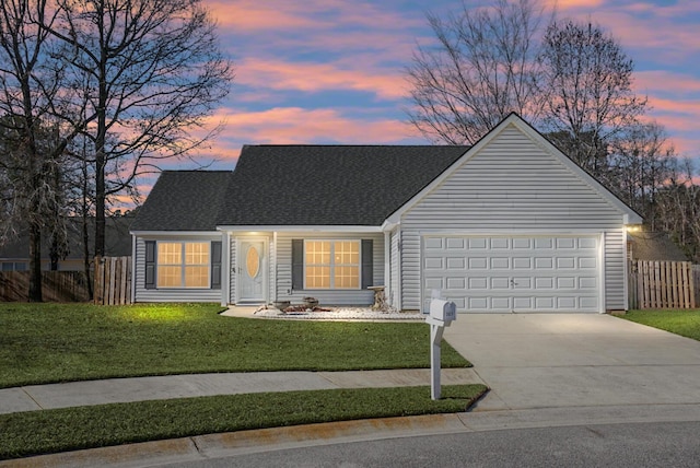 view of front of house featuring a yard and a garage