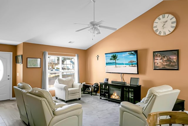 living room featuring light hardwood / wood-style flooring, ceiling fan, and lofted ceiling