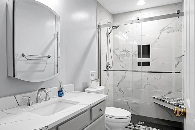 bathroom with vanity, toilet, and walk in shower