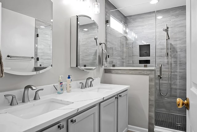 bathroom with vanity and a shower with door