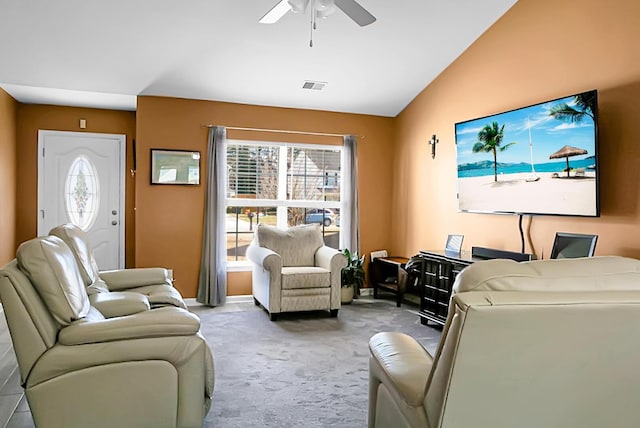 carpeted living room featuring ceiling fan and vaulted ceiling