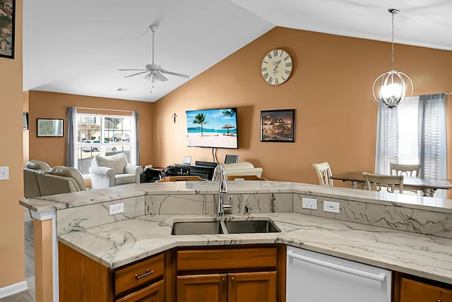 kitchen featuring ceiling fan, sink, white dishwasher, pendant lighting, and vaulted ceiling