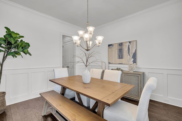 dining room featuring ornamental molding, dark wood-type flooring, and a notable chandelier