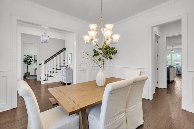 dining area featuring ceiling fan with notable chandelier, crown molding, and dark hardwood / wood-style floors