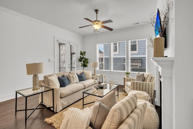 living room featuring dark hardwood / wood-style flooring, ceiling fan, and crown molding