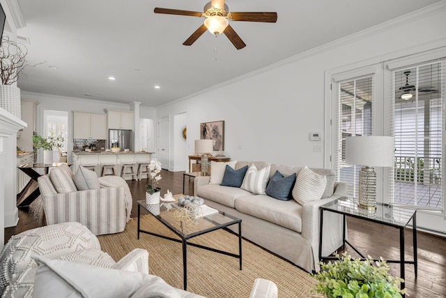 living room with ceiling fan, ornamental molding, and light hardwood / wood-style flooring