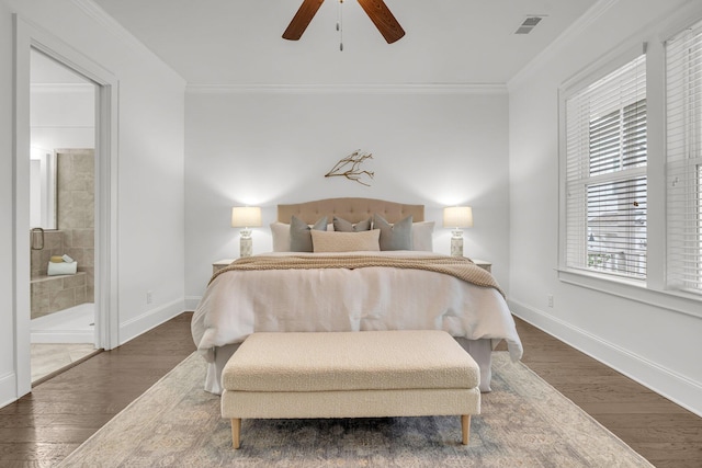 bedroom with ensuite bath, ceiling fan, crown molding, and dark wood-type flooring