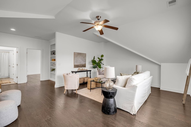 living room featuring ceiling fan, dark wood-type flooring, vaulted ceiling, and built in shelves