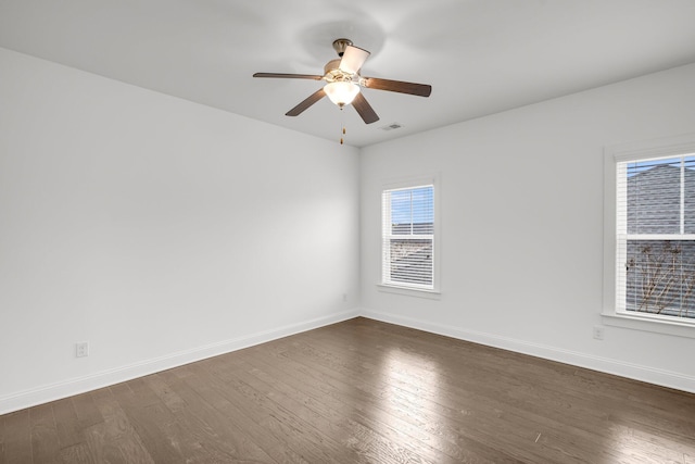 spare room featuring ceiling fan and dark hardwood / wood-style floors