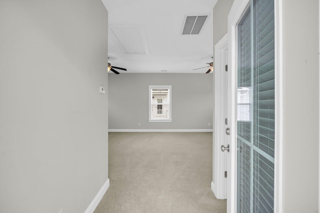 hall featuring light colored carpet