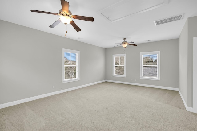 spare room with ceiling fan and light colored carpet