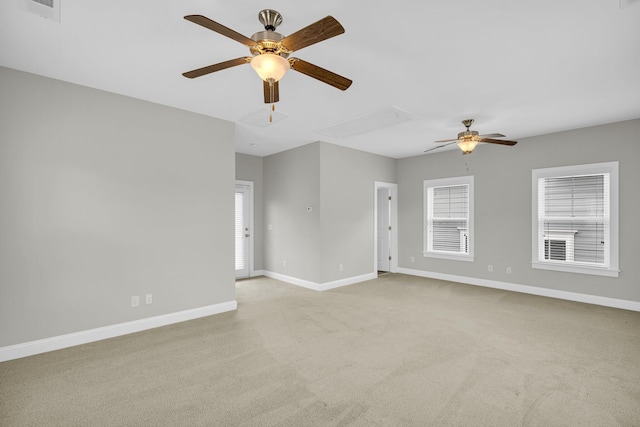 carpeted spare room with ceiling fan