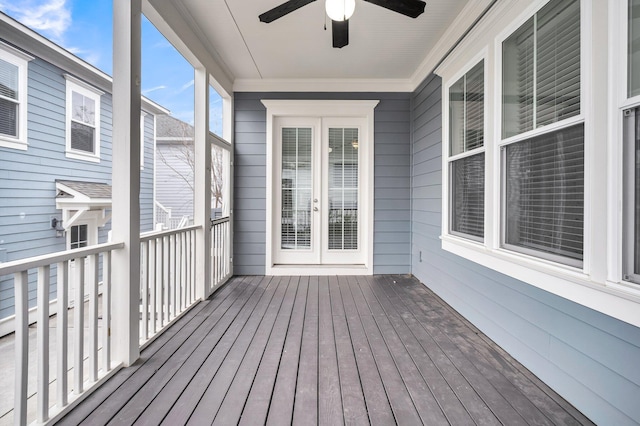 unfurnished sunroom with ceiling fan