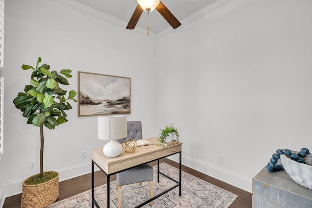 home office with dark wood-type flooring and ornamental molding