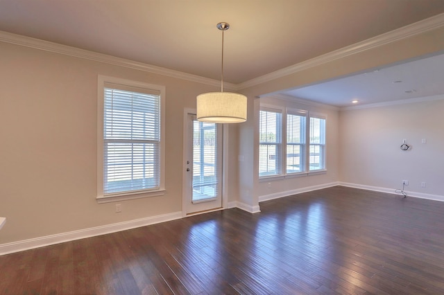 spare room featuring ornamental molding and dark hardwood / wood-style floors