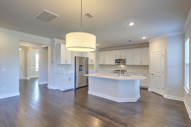 kitchen with an island with sink, white cabinetry, and stainless steel appliances