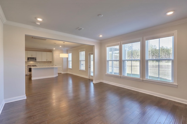 unfurnished living room featuring dark hardwood / wood-style flooring and ornamental molding