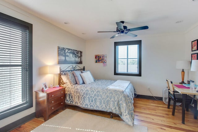 bedroom featuring ceiling fan, wood-type flooring, and crown molding