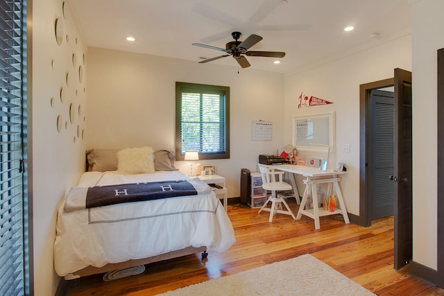 bedroom with ceiling fan and light hardwood / wood-style flooring