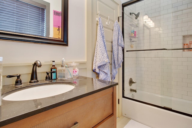 bathroom featuring tiled shower / bath combo and vanity