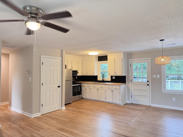 105 Dandridge Rd, Walterboro, SC 29488 - kitchen featuring a textured ceiling, light wood finished floors, white cabinets, ceiling fan, and range with electric stovetop
