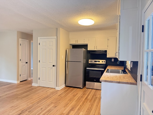 105 Dandridge Rd, Walterboro, SC 29488 - kitchen featuring stainless steel appliances, a sink, range hood, white cabinets, and light wood finished floors