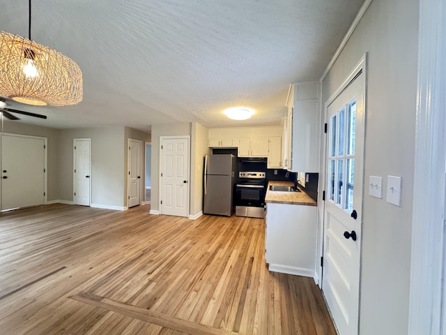 105 Dandridge Rd, Walterboro, SC 29488 - kitchen featuring freestanding refrigerator, stove, white cabinets, light wood finished floors, and ceiling fan