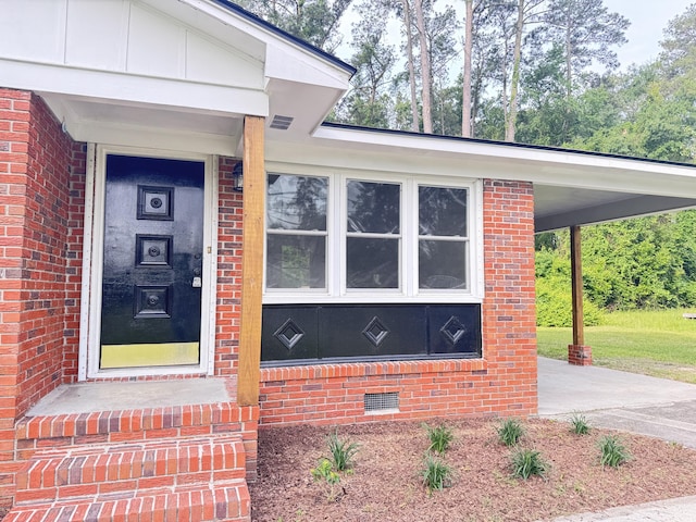 105 Dandridge Rd, Walterboro, SC 29488 - property entrance featuring concrete driveway, brick siding, and an attached carport