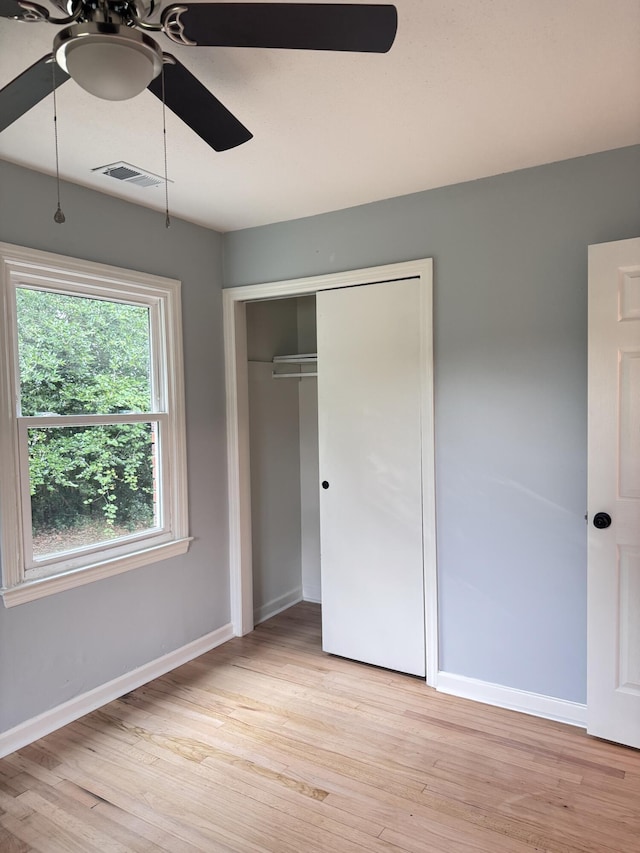 105 Dandridge Rd, Walterboro, SC 29488 - unfurnished bedroom with light wood-type flooring, baseboards, a ceiling fan, and a closet