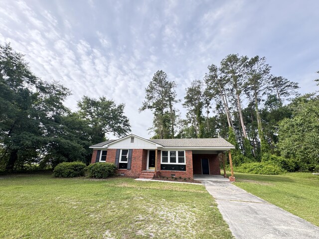 105 Dandridge Rd, Walterboro, SC 29488 - single story home featuring brick siding, concrete driveway, a carport, and a front yard