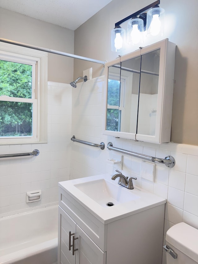 105 Dandridge Rd, Walterboro, SC 29488 - full bath featuring toilet, vanity, tile walls, and washtub / shower combination