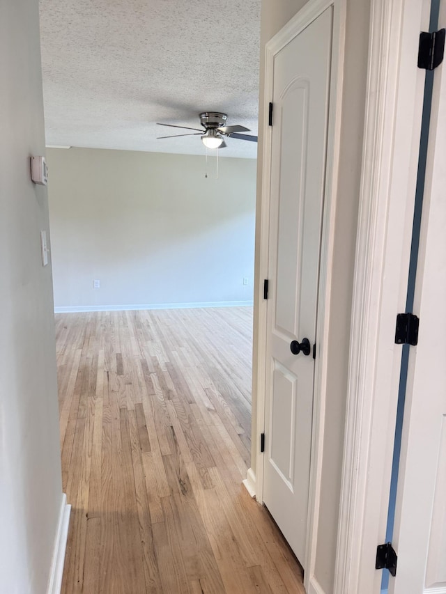 105 Dandridge Rd, Walterboro, SC 29488 - hallway with light wood-type flooring, a textured ceiling, and baseboards