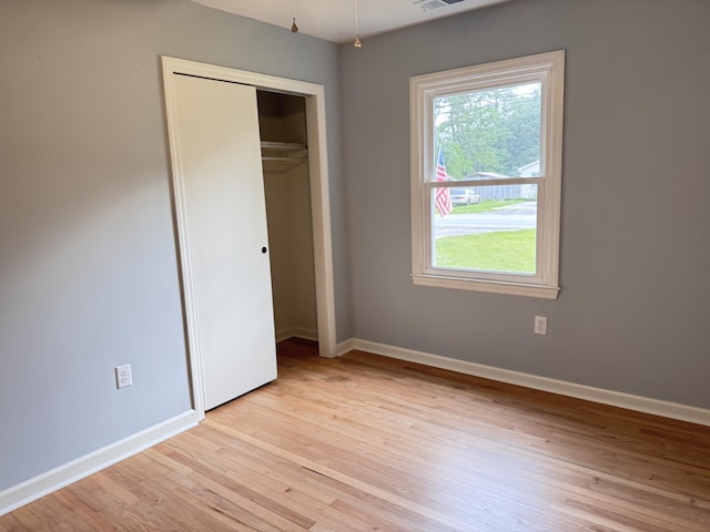 105 Dandridge Rd, Walterboro, SC 29488 - unfurnished bedroom with multiple windows, light wood finished floors, and baseboards