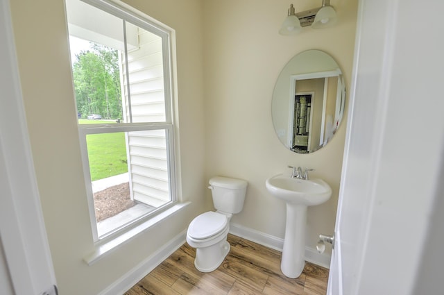 bathroom with sink, hardwood / wood-style floors, and toilet