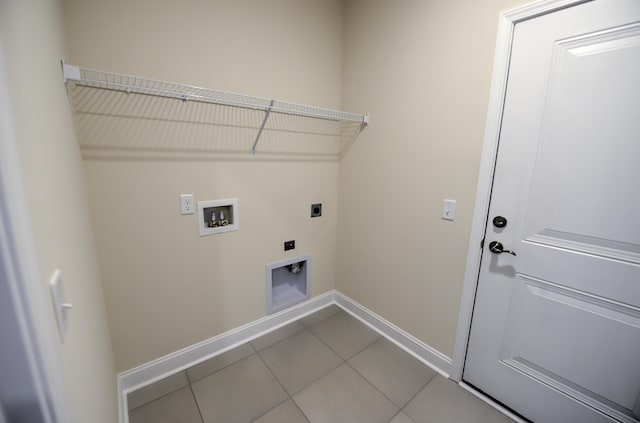 washroom with hookup for a washing machine, hookup for an electric dryer, and tile patterned floors