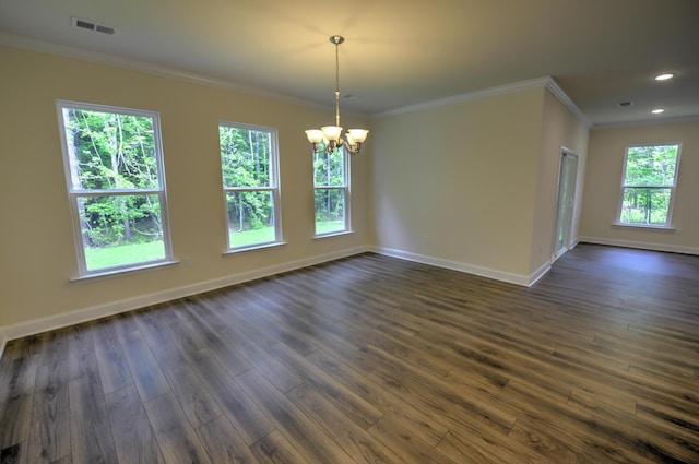 unfurnished dining area with dark hardwood / wood-style flooring, crown molding, and a chandelier