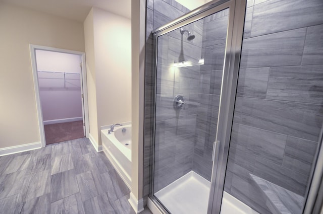 bathroom with separate shower and tub