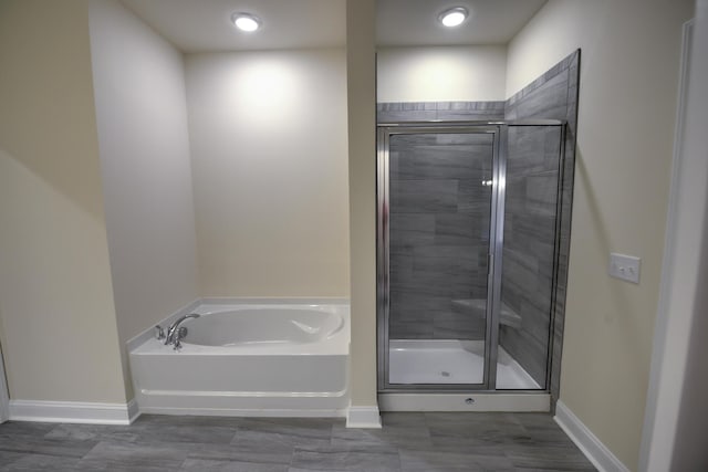 bathroom featuring separate shower and tub