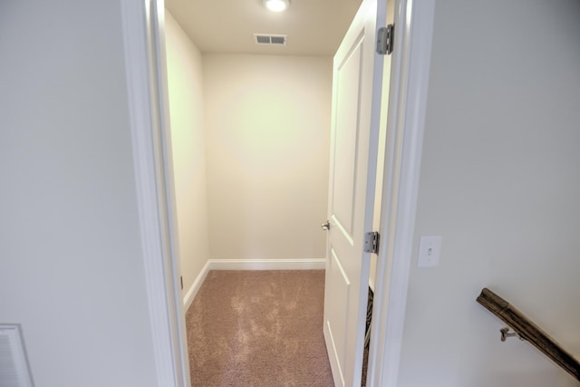 hall with light colored carpet