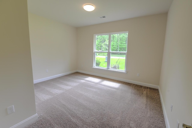 empty room featuring light colored carpet