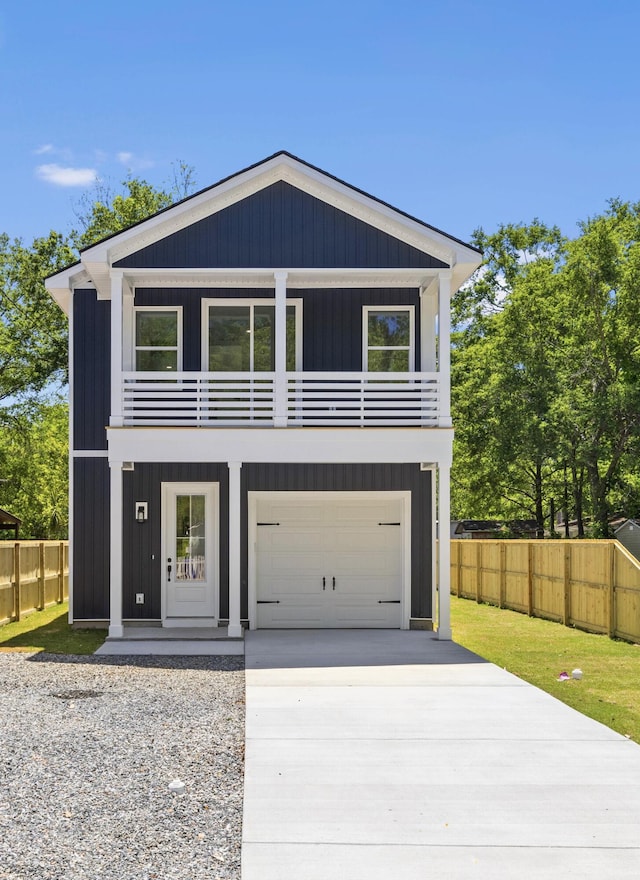 1917 Jason St, North Charleston, SC 29406 - view of front facade with fence, an attached garage, concrete driveway, and a balcony