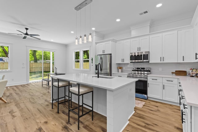 1917 Jason St, North Charleston, SC 29406 - kitchen featuring crown molding, light countertops, plenty of natural light, stainless steel appliances, and visible vents